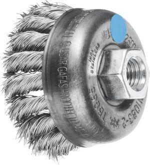 a close up of a wire brush with a nut on it